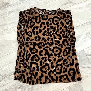 Animal print blouse shoulder pad detail.